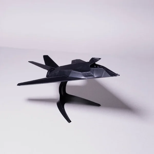 A detailed 3D printed black fighter jet model displayed on stand by Print3D.pk.