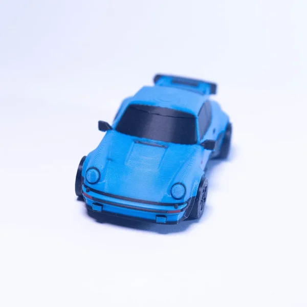 A detailed blue 3D printed Porsche model car by Print3D.pk on a white background.