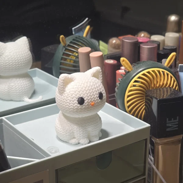 A charming white knitted cat figurine from Print3D.pk, perfect decorative piece for cat lovers.