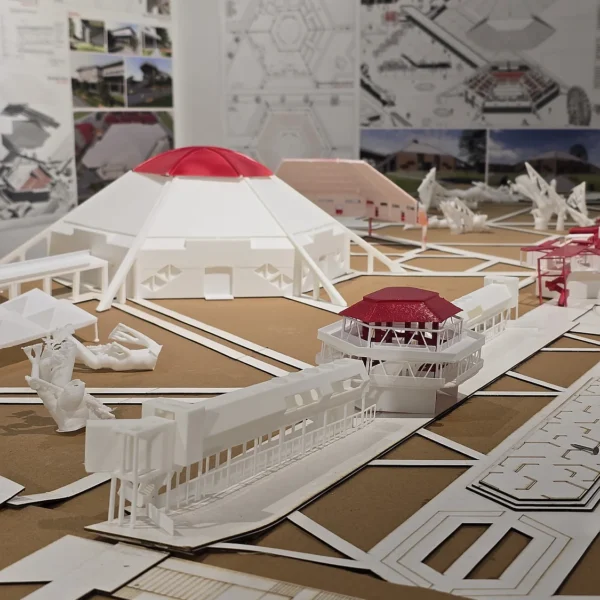 Detailed 3D printed architectural model with red roofs and figures by Print3D.pk.