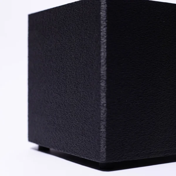 A high-quality 3D printed black cube model with textured surface from Print3D.pk.