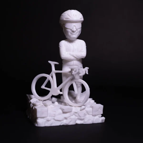 A detailed 3D printed cyclist figurine on rocky base by Print3D.pk for decorative purposes.