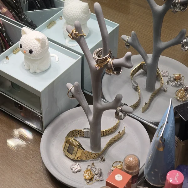 A 3D printed jewelry tree holder from Print3D.pk displaying rings and bracelets stylishly.