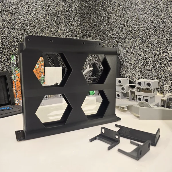 A 3D printed hexagonal wall panel and parts by Print3D.pk for decorative and functional use.