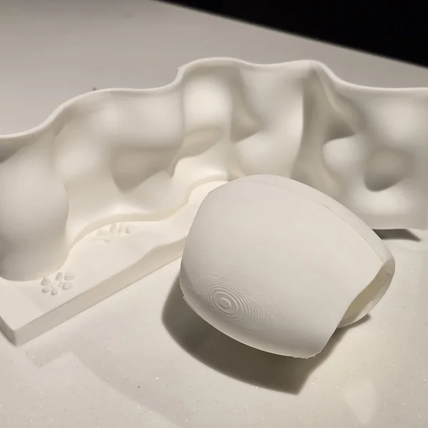 A 3D printed white object holder and base from Print3D.pk for organizing small items.