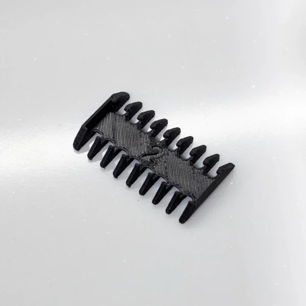 A black 3D printed comb by Print3D.pk for efficient hair styling and grooming needs daily.