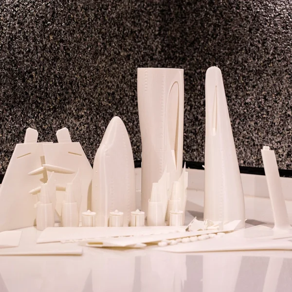 A 3D printed city skyline model featuring various buildings and structures from Print3D.pk.